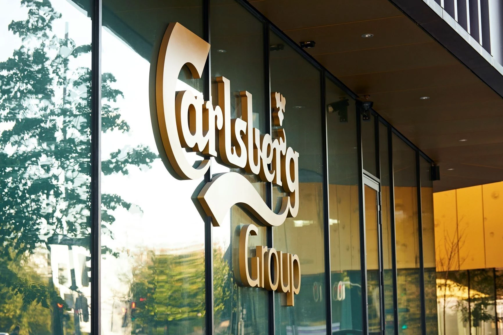 Carlsberg: Carlsberg Group logo displayed on a glass office entrance.