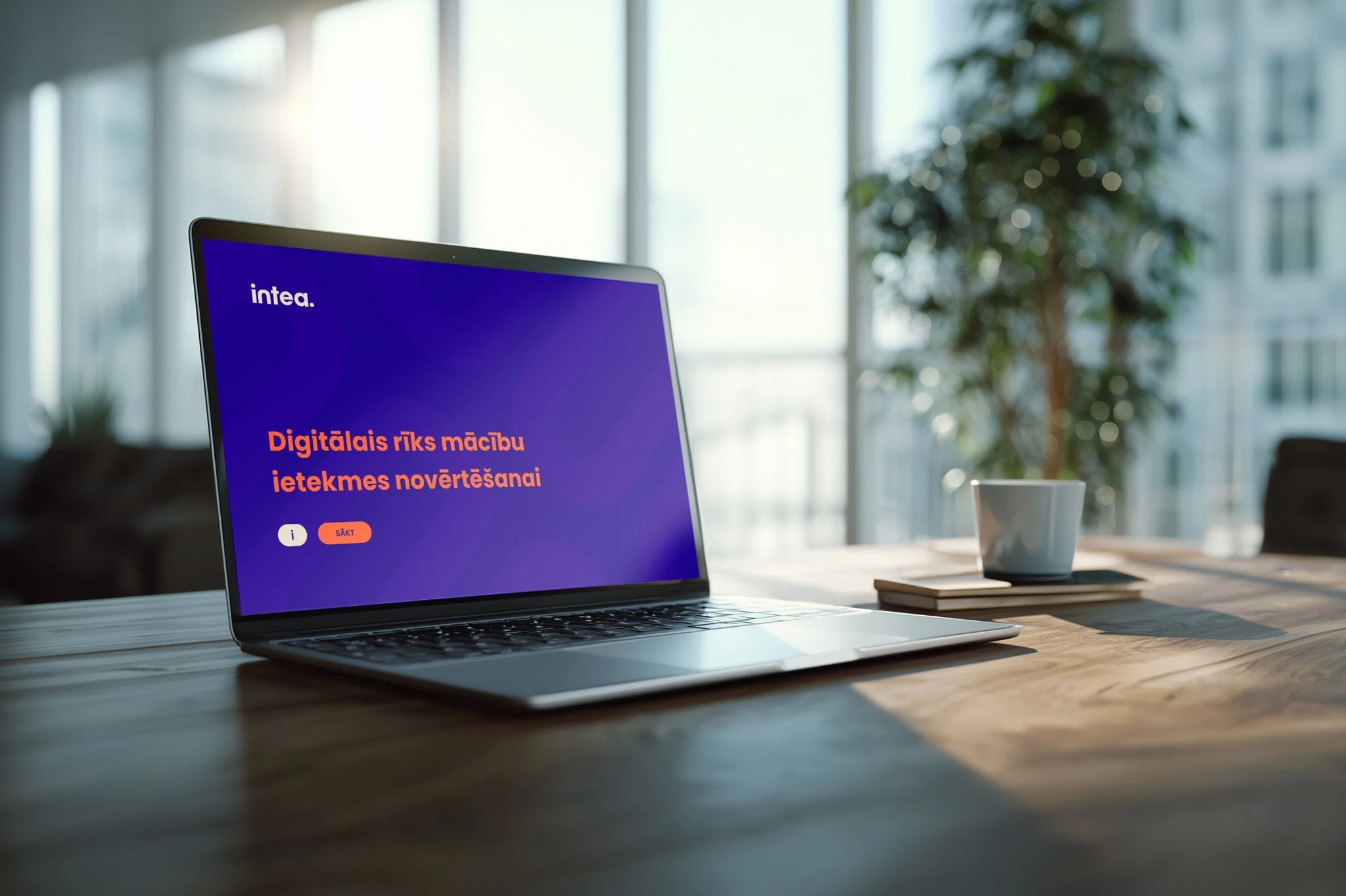 Laptop displaying an intea. digital learning course on a wooden table.