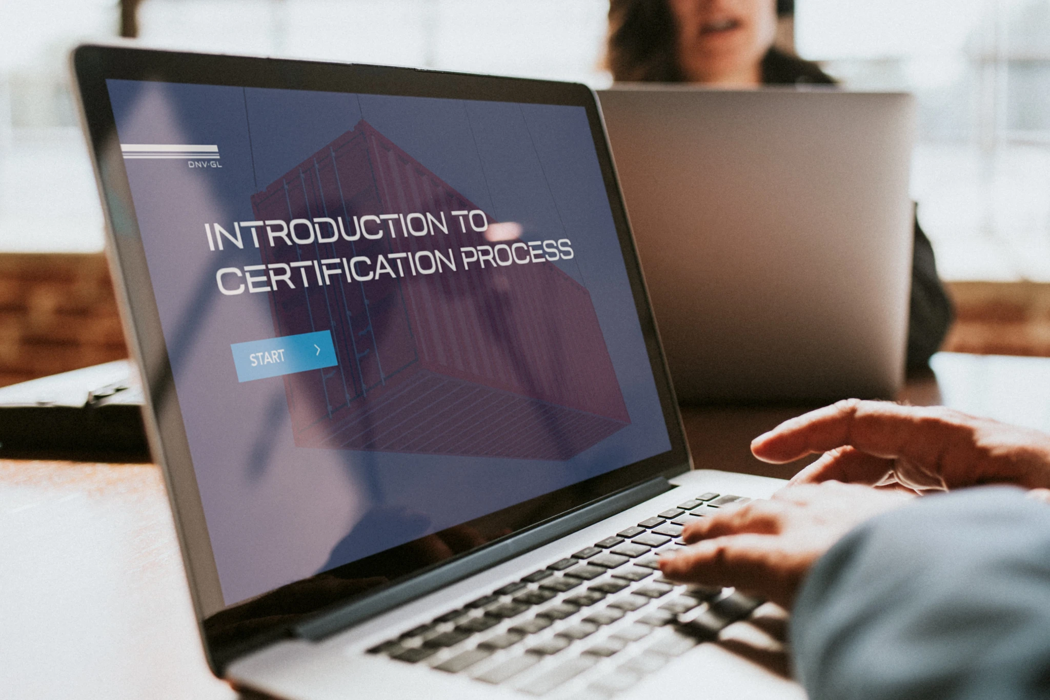 Person using a laptop displaying an introduction to the certification process.
