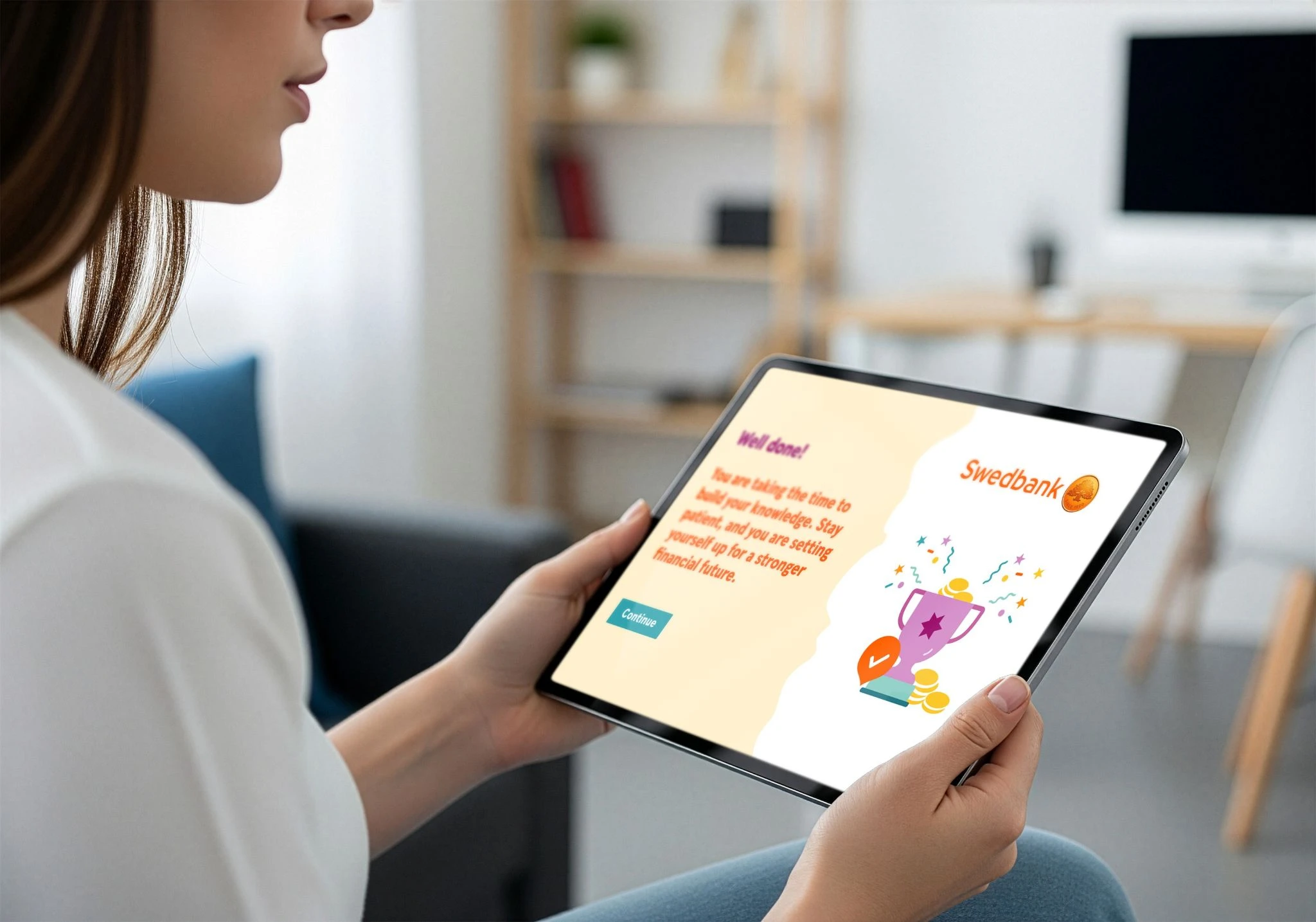 Woman holding a tablet displaying a Swedbank financial education screen.